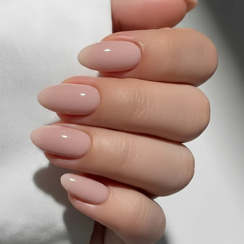 Short almond nails in office appropriate professional setting with BIAB polished finish showing work ready elegant manicure