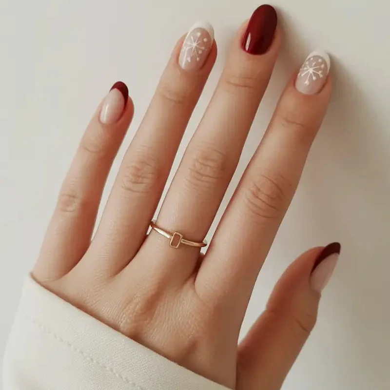 short christmas nails office appropriate design with burgundy polish and minimalist gold accent professional