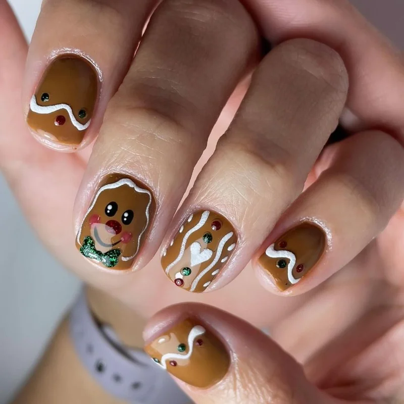 short square christmas nails with cute gingerbread cookie design brown polish and white icing details