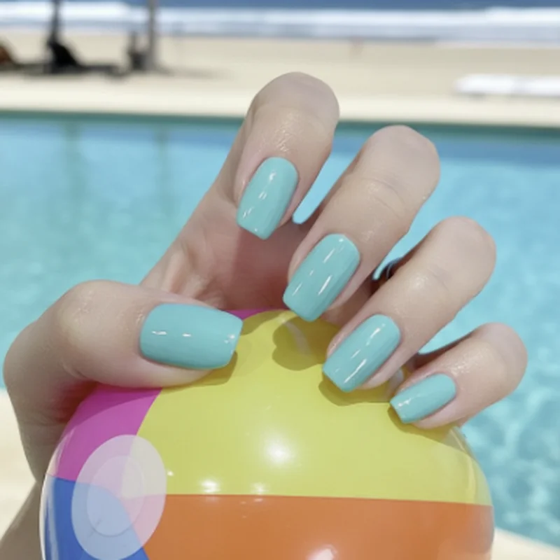 Short squoval nails at beach and pool summer lifestyle showing practical active manicure with gel polish and natural nail bed length
