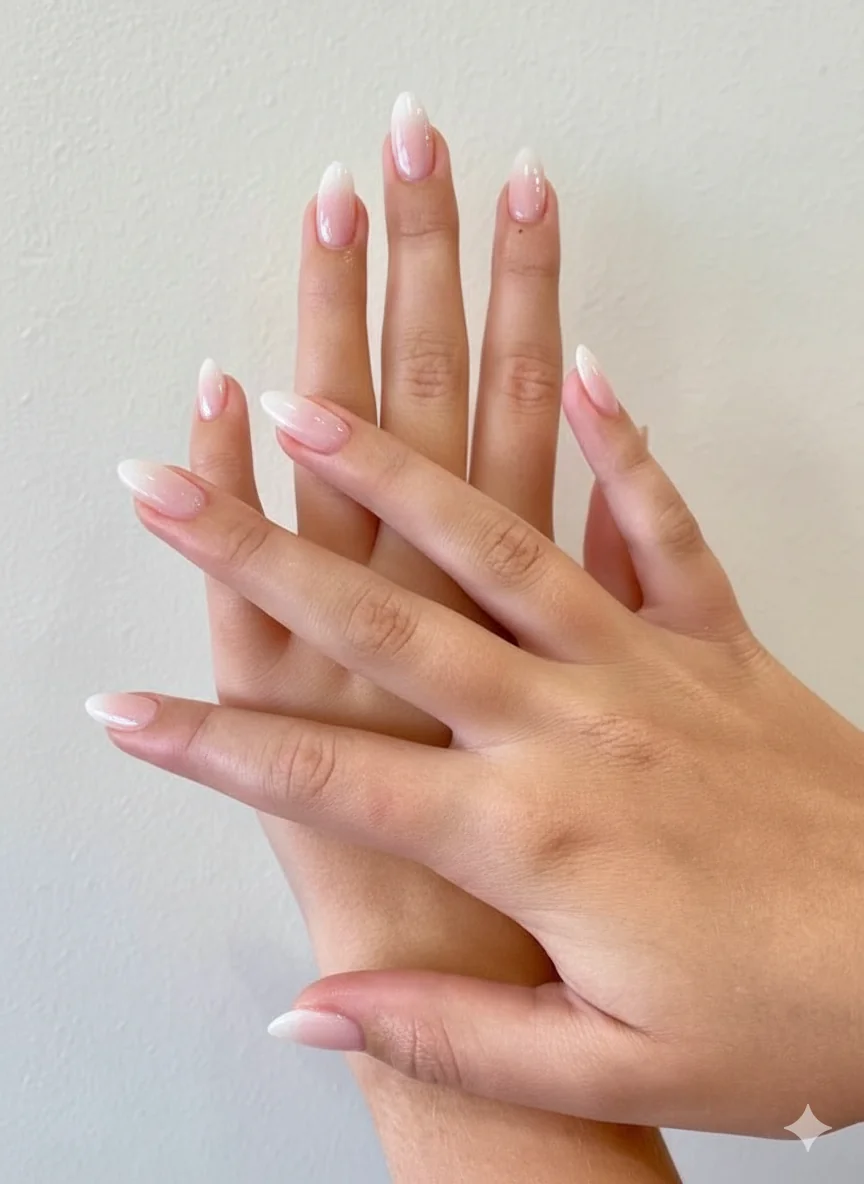 Soft ombre nails showing blush to milky white gradient achieved with sponge technique tonal blend on natural oval nail shape spring