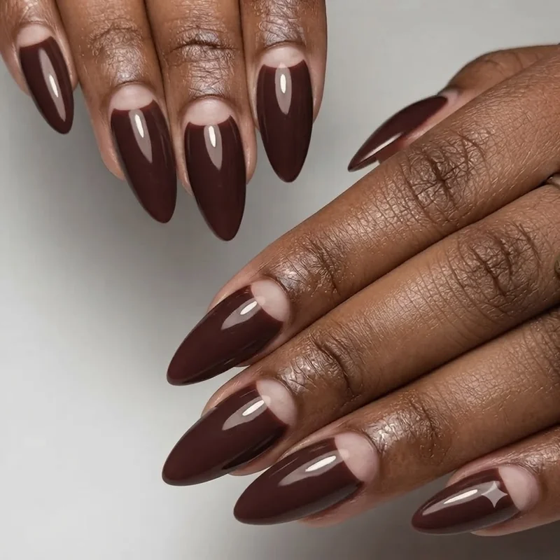 Half-moon negative space nails created using a reinforcement sticker for a curved bare crescent line