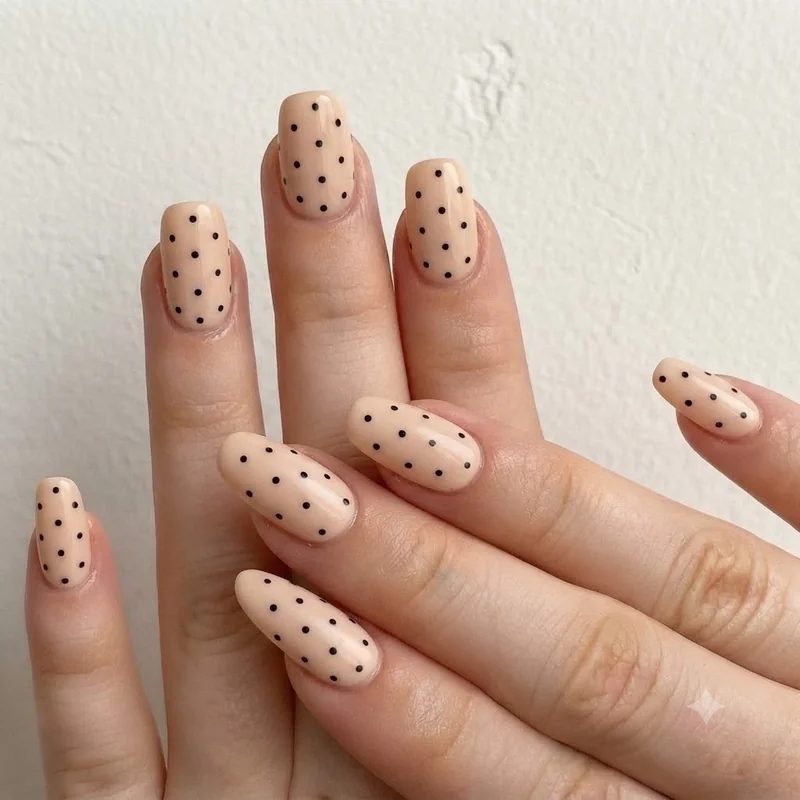 Polka dot nail art on neutral base as easy nail designs for short nails everyday wear