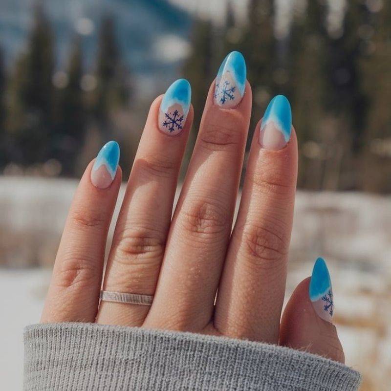 Ski resort vacation nails with cozy winter themed manicure and snowflake designs