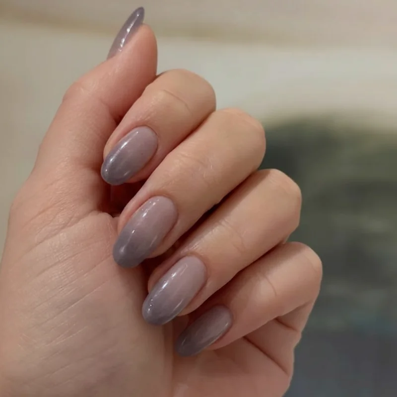 Lavender nails 2026 in jelly watercolour finish showing soft greyed purple haze on medium length nails for spring editorial