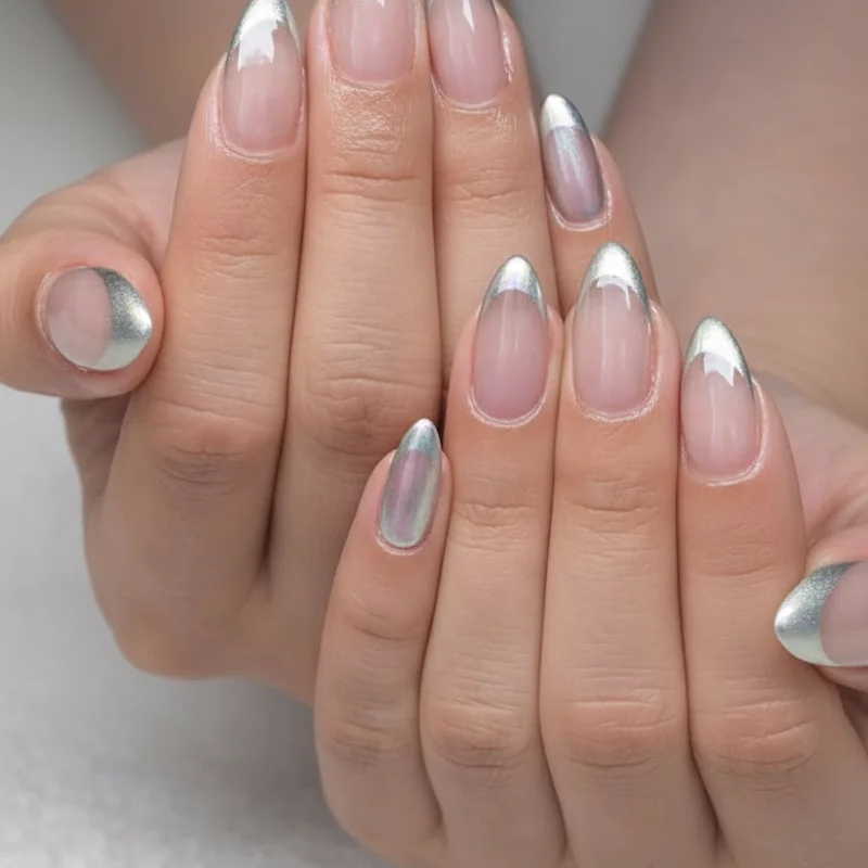 Chrome French tip nails spring 2026 iridescent silver mirror finish on almond shape bridal editorial high gloss modern style
