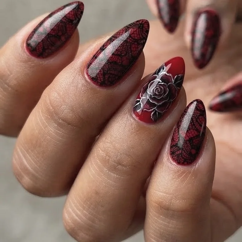 Black lace over red gothic stiletto nails with a dark romance rose motif accent nail