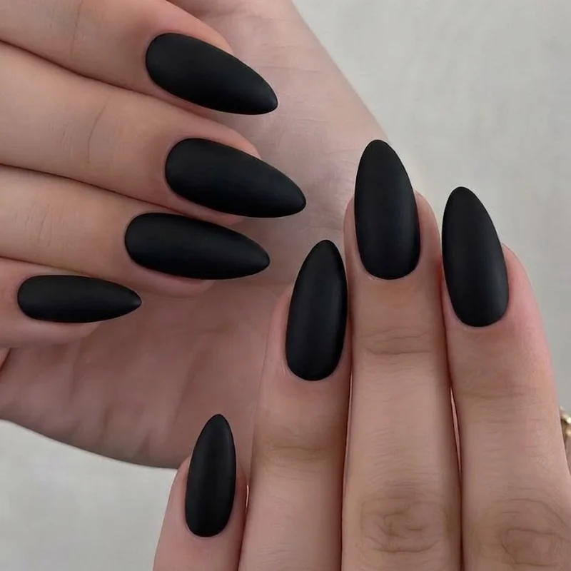 Matte black gothic stiletto nails in a clean editorial set establishing the shape and finish before motif variety begins
