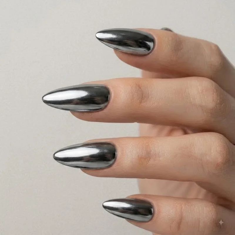 Gunmetal chrome gothic stiletto nails with a metallic futuristic finish and mirror shine detail