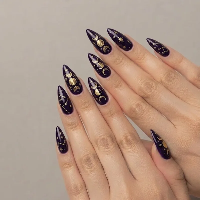 Celestial witchy gothic stiletto nails in midnight violet with moon phase and star detailing