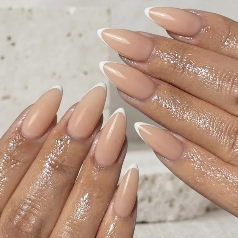 Ultra-thin micro french line on nude stiletto nail base with minimalist styling