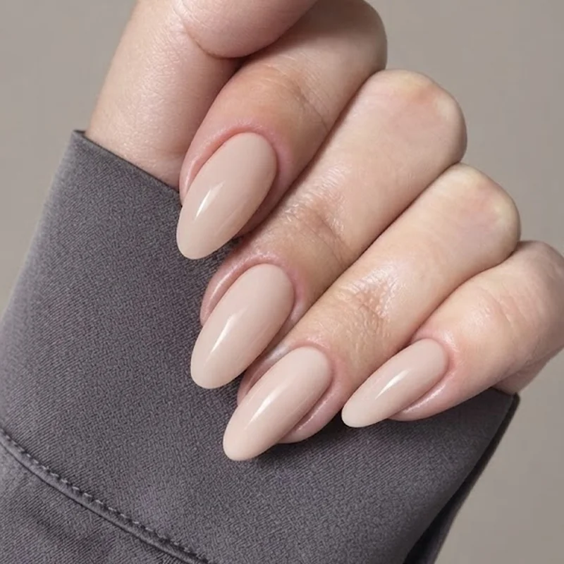 Stiletto manicure ideas in caramel cream and blush pink matte finish on a medium length set