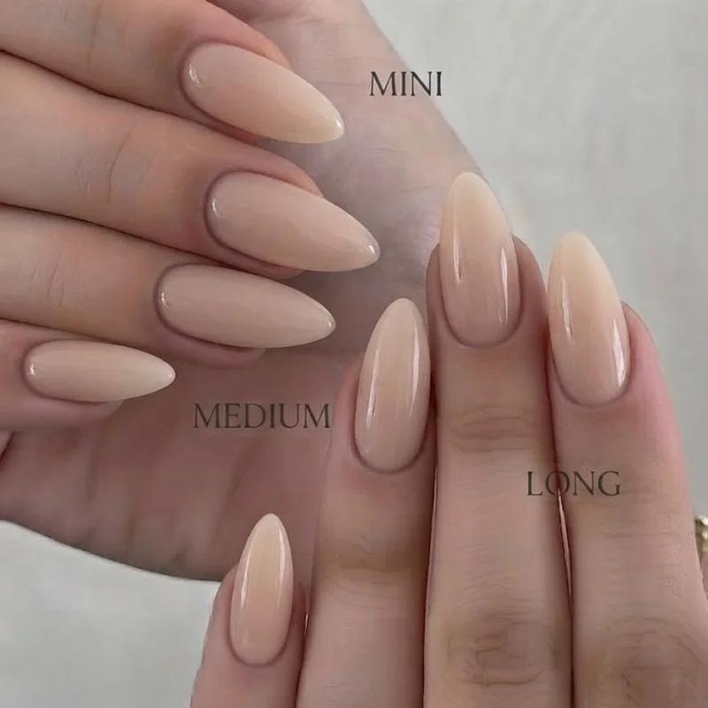 Stiletto nail ideas featuring a milky nude glossy finish on a classic long stiletto manicure set