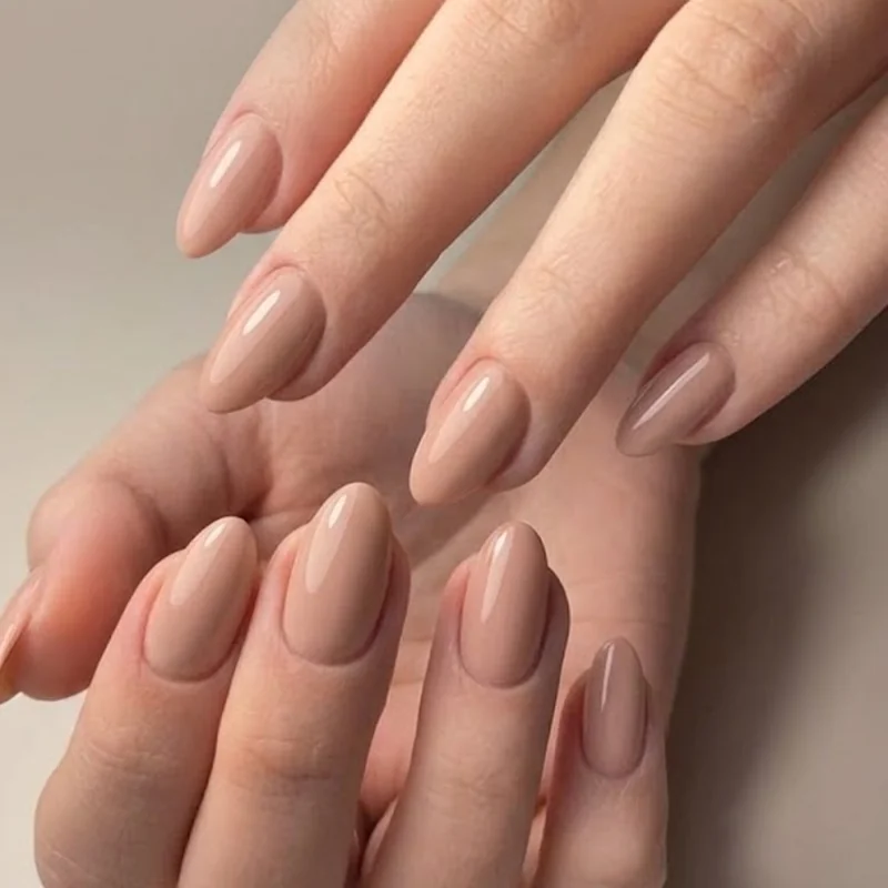 Almond nail set medium length glossy finish demonstrating durable everyday manicure option