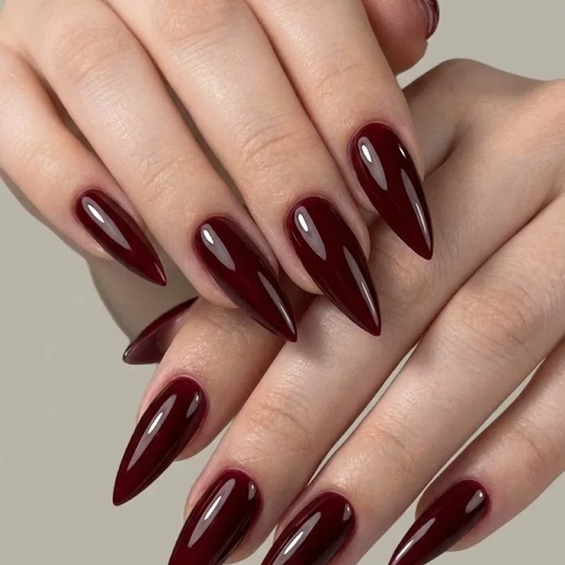 Long dramatic stiletto nail set sharp point showing full visual impact and elongating effect