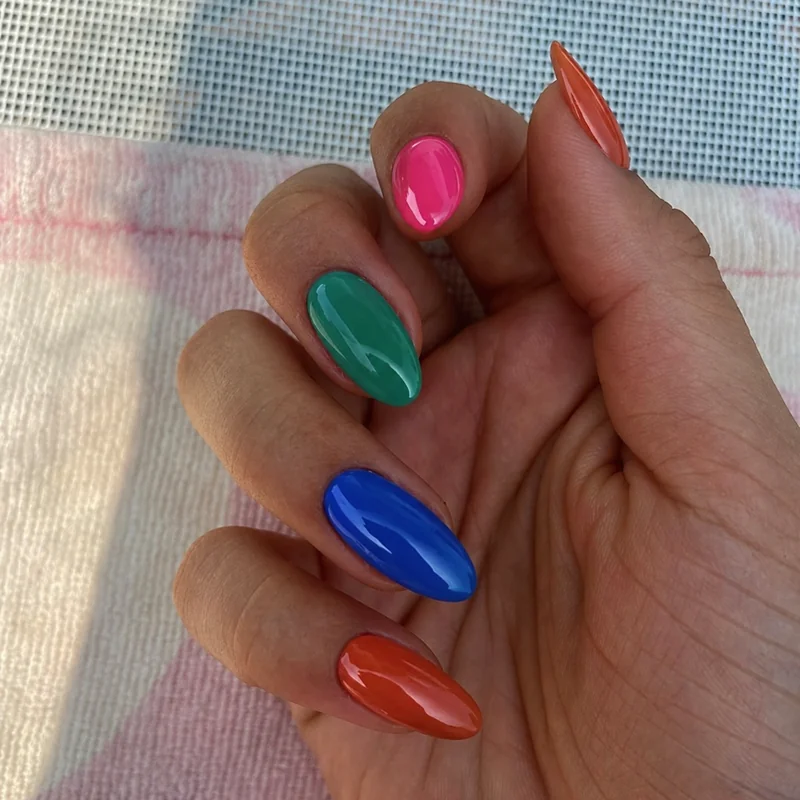 Best summer nail colours for dark and deep skin tones featuring hot pink jade green cobalt blue and terracotta orange polish swatches
