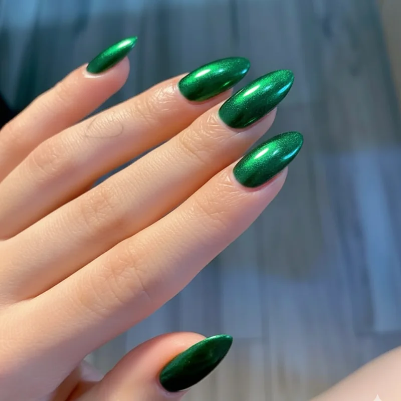 Chrome jade green nail polish on deep skin tone summer manicure showing metallic reflective finish close up hand detail