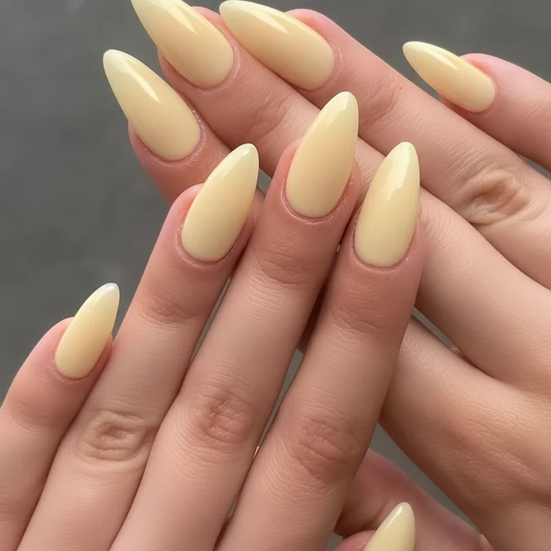 Butter yellow nail ideas summer 2026 creamy warm tone on almond and squoval shapes with high gloss gel nail finish