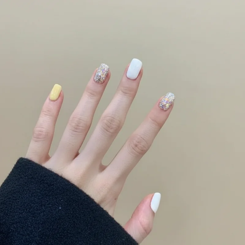 Summer 2026 out nail trends butter yellow thick French tips stark white and chunky glitter losing seasonal relevance comparison