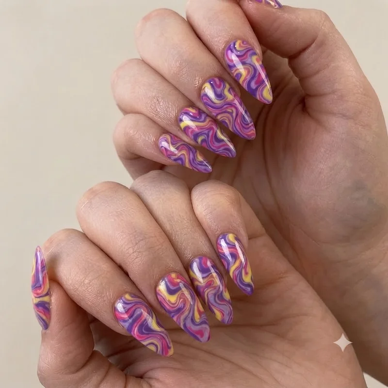 Press on nail set styled as a flat lay showing abstract swirl tame impala design