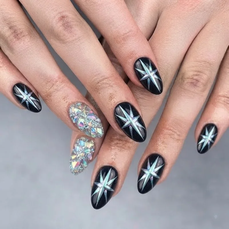 Bold chrome starburst opalite manicure with maximalist iridescent finish on dark polish base