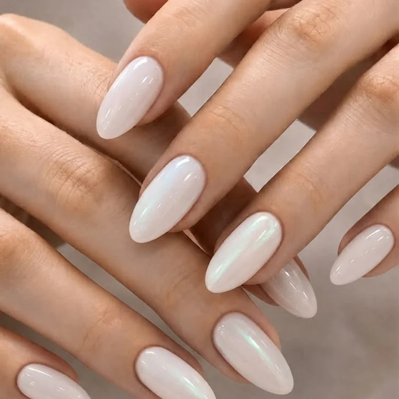 Milky iridescent opalite nails on short almond shape showing color-shifting effect in daylight