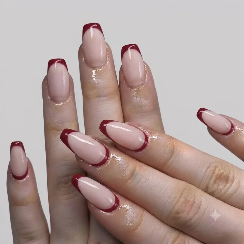 Gold foil french tip thanksgiving nails design styled for a glamorous holiday hand shot