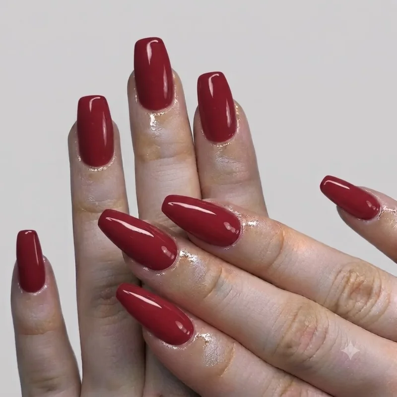 Gold chrome and rhinestone accented cat eye statement manicure in burgundy for Thanksgiving