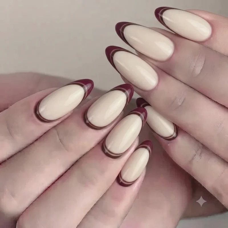 Milky beige and espresso brown neutral almond manicure with fine gold line accent detail