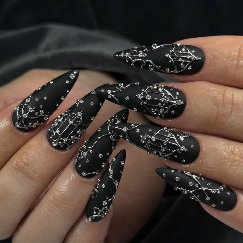 Gothic vampire nails with rhinestones and metallic accents