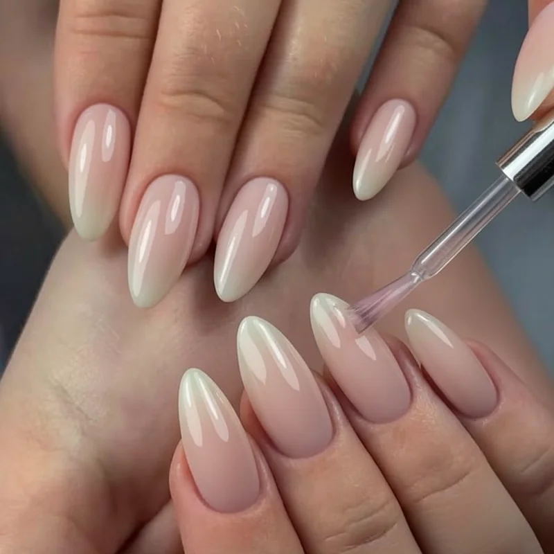Gel polish thin coat application swatches progressing from one coat to three coats on sheer pink oval nail shape examples