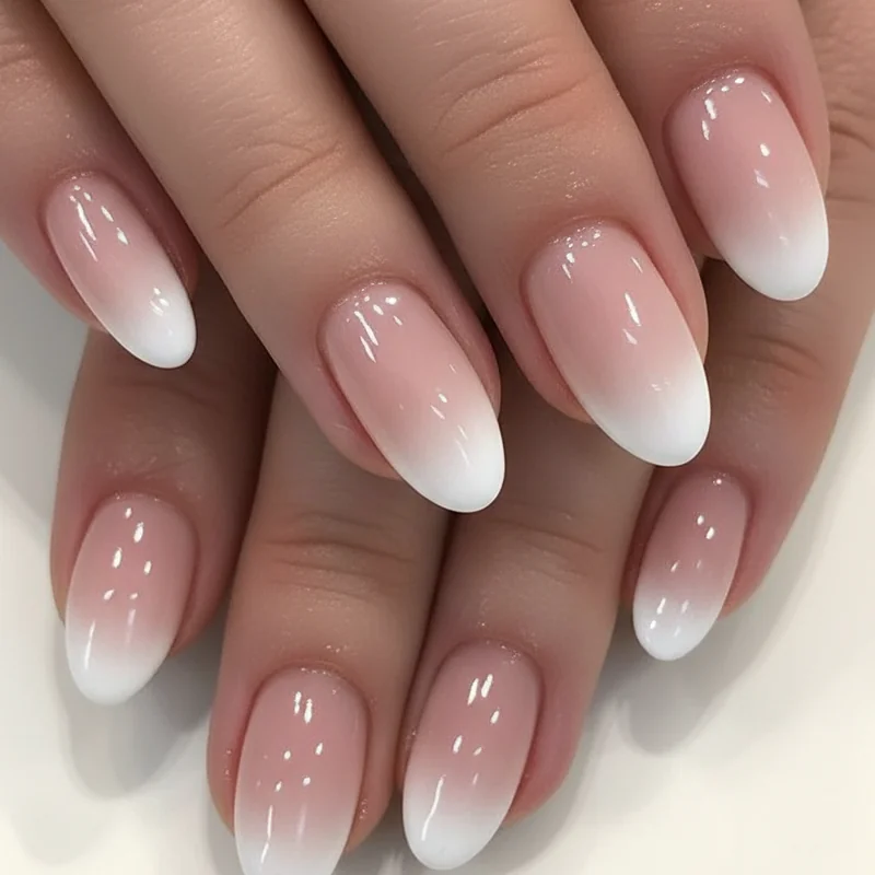 Baby boomer French wedding nails with a soft pink to white gradient fade ideal for close up bridal ring shot photography