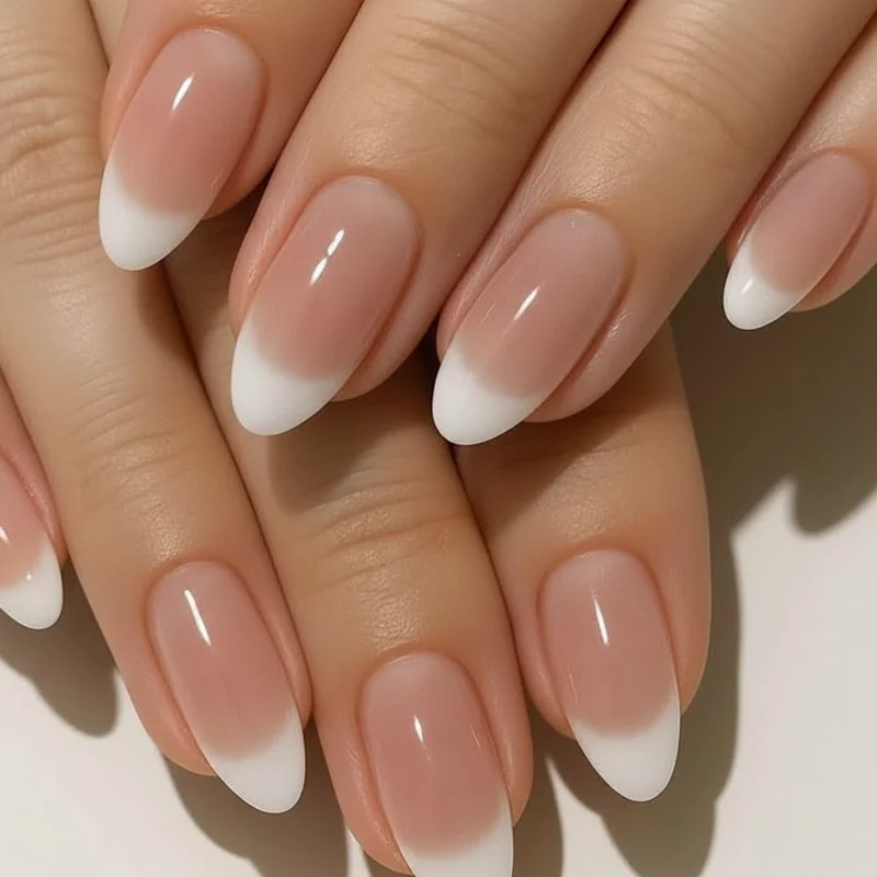 2026 French tip evolution with a milky close toned base and a soft diffused white tip on oval almond shaped bridal nails