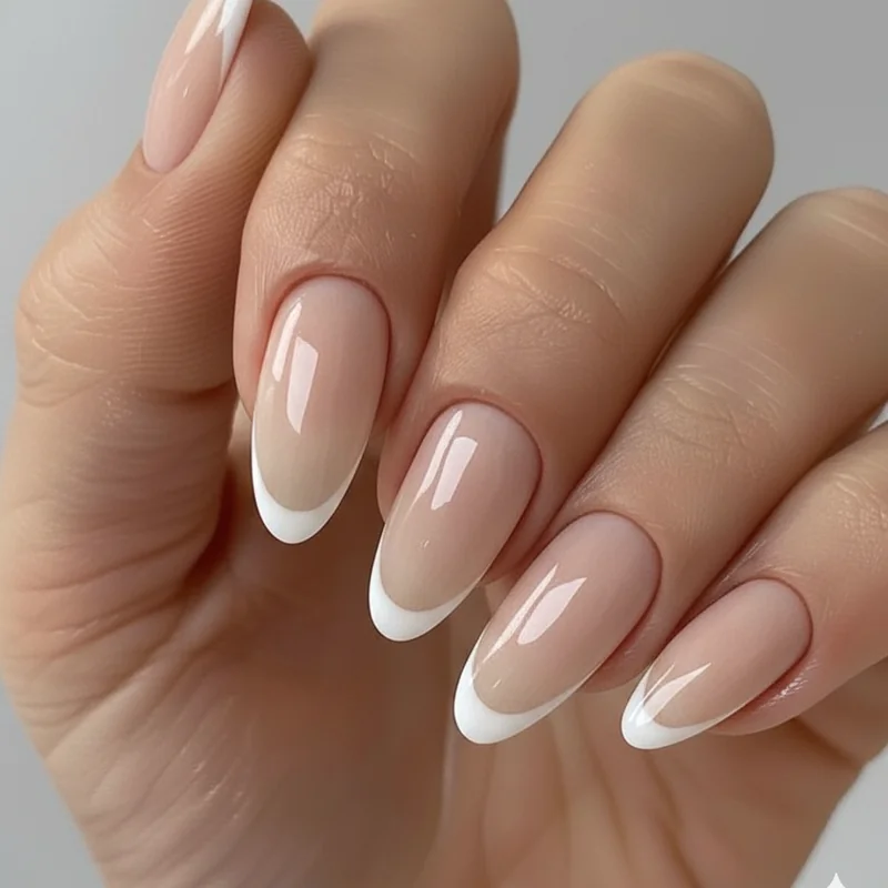 Micro French tip wedding nails with an ultra thin white tip line under one millimetre on a milky sheer pink almond shape