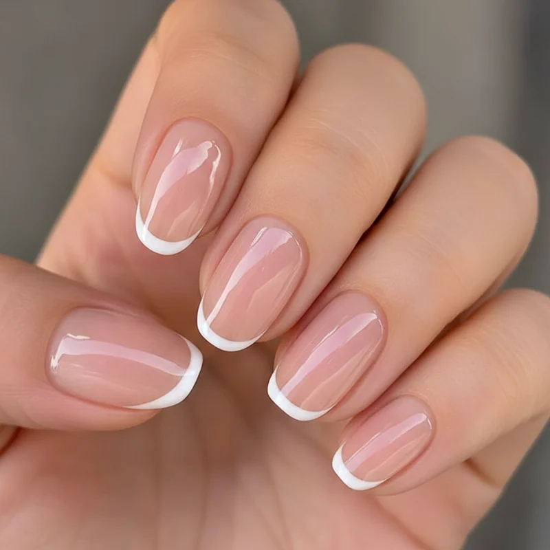 Micro French tip on short wedding nails with hairline white edge on squoval shape for a modern and refined bridal finish