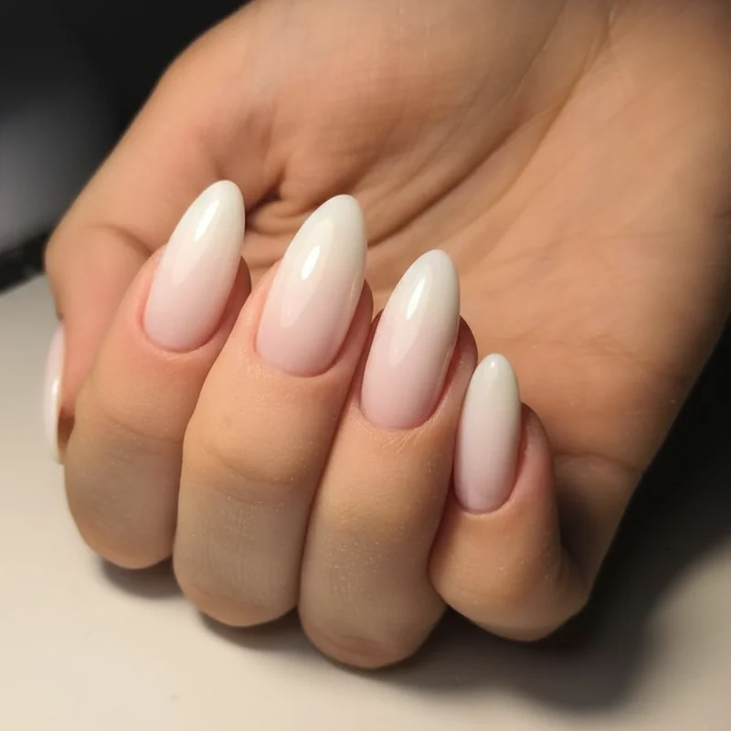 Quiet luxury short bridal nails showing sheer milky base finish on squoval shape representing the 2026 no-mani mani trend