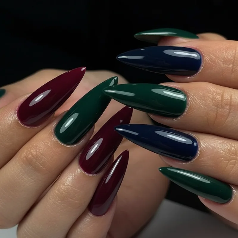 Bold wedding guest nail colours showing classic red burgundy forest green and deep navy jewel tones with context for when each works