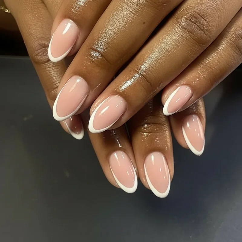 Micro-French tip bridal nails 2026 showing hairline soft white edge on almond shape beside diamond engagement ring