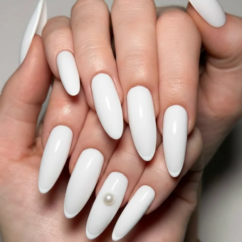Pearl accent ring finger bridal nails 2026 with micro-French on milky base showing freshwater pearl placement near cuticle