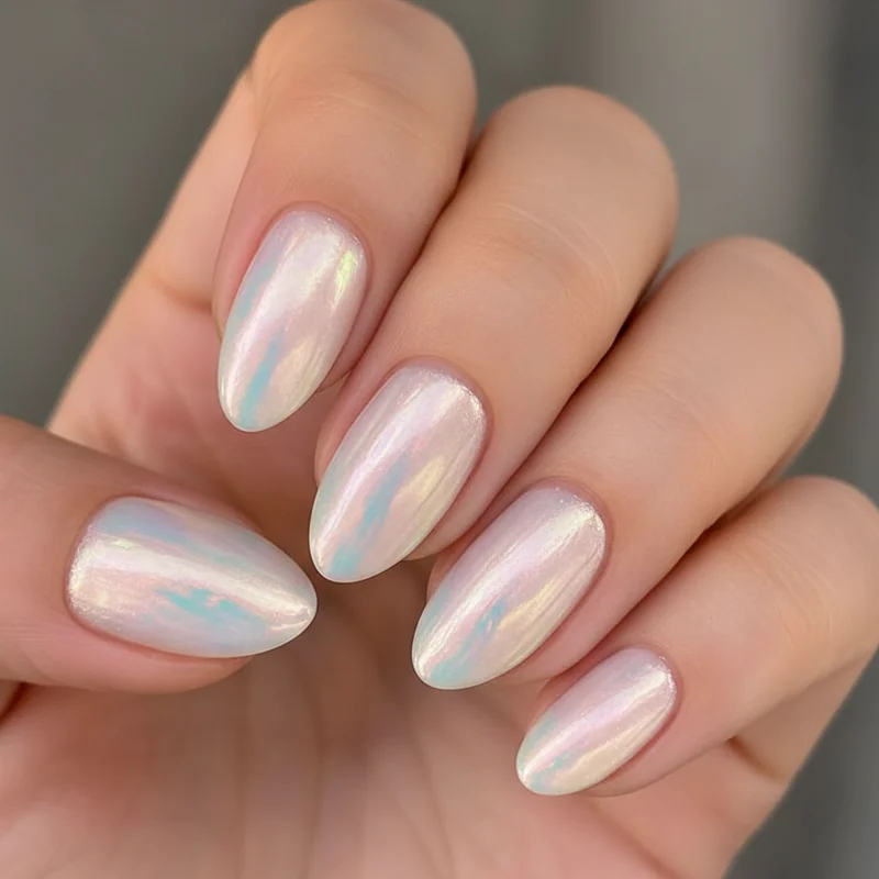 Pearl chrome opalescent bridal nails 2026 over sheer blush base showing soft iridescent glow in reception lighting