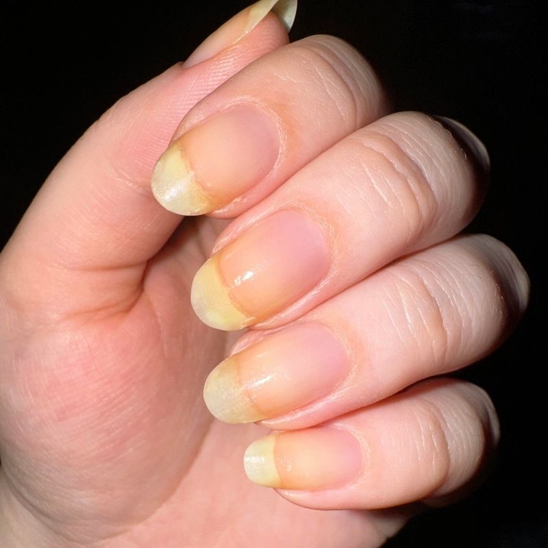 white nail polish yellowing prevention showing proper base coat application technique creating protective barrier layer