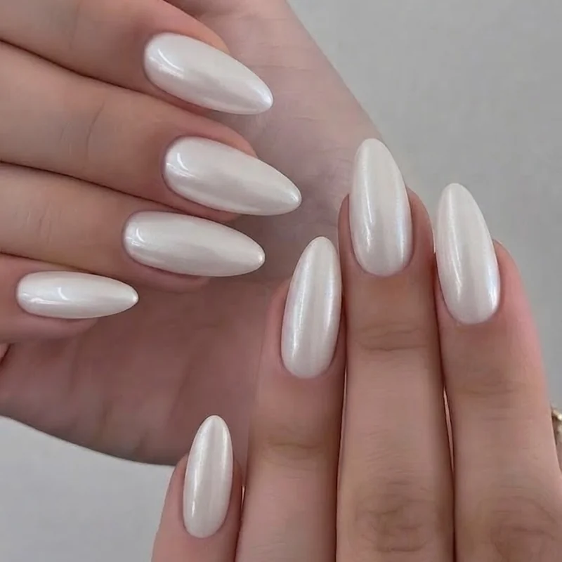 White chrome pearl finish manicure styled for an evening formal wedding guest look with subtle light-catching shimmer effect