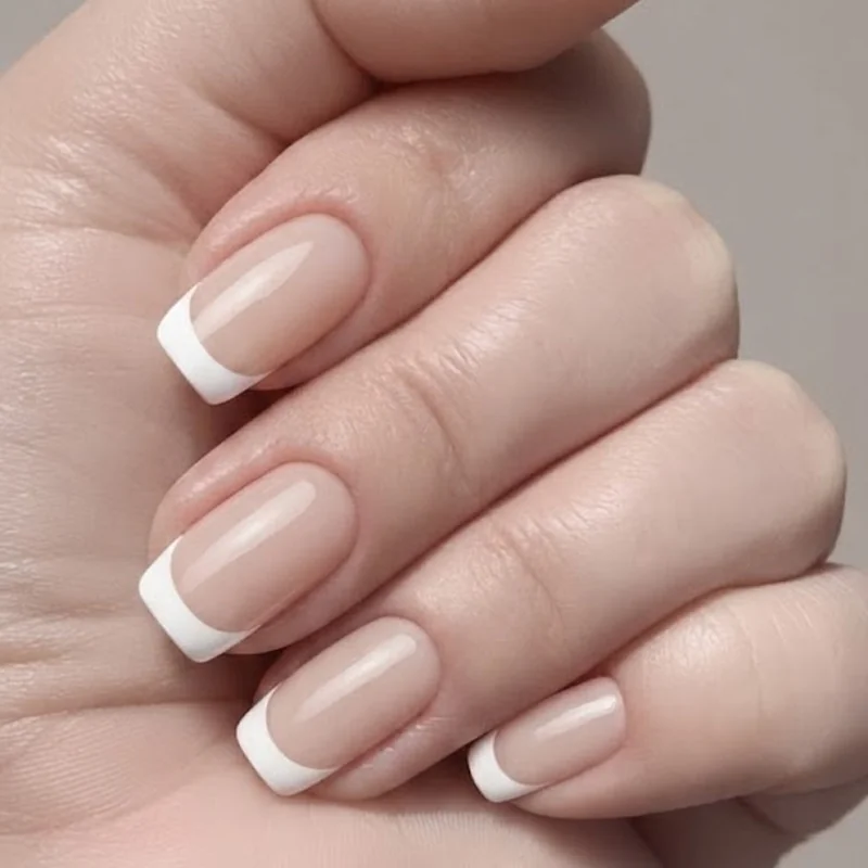 White French tip manicure in an elegant short to medium length, styled specifically for wedding guest nail inspiration today