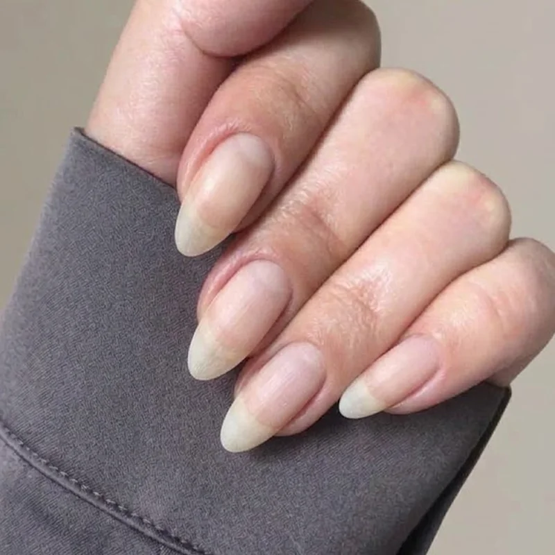 Bare healthy-looking natural nails on a cozy winter surface, a clean natural look for nails recovering from winter dryness