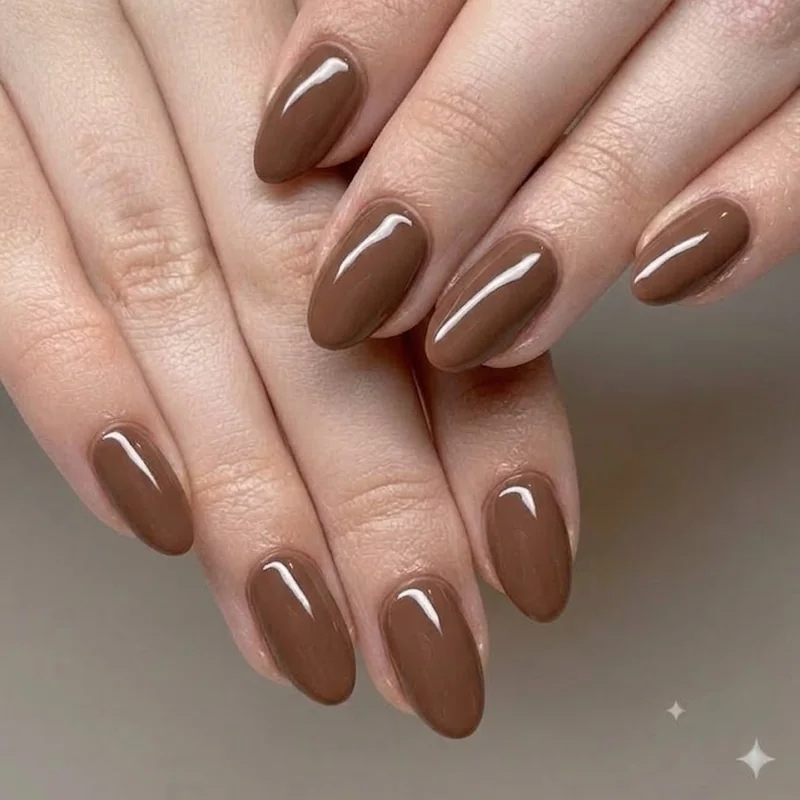 Classic chocolate brown winter nails in glossy short almond shape, baseline everyday manicure
