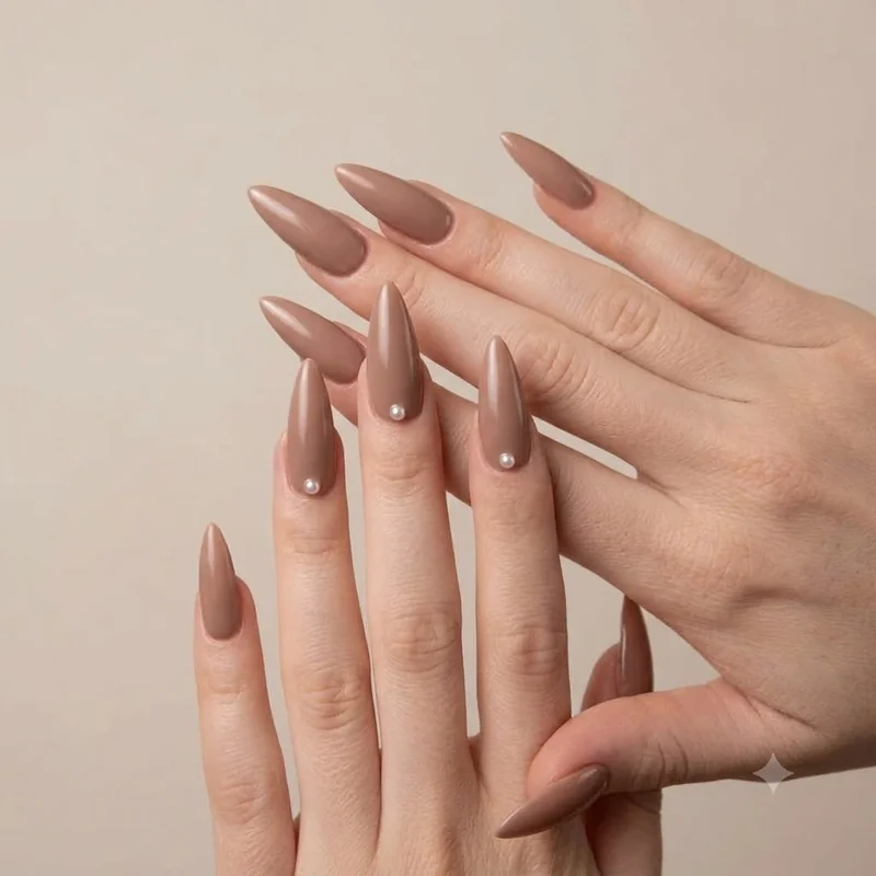 Mocha mousse nails with tiny pearl cuticle accent, delicate winter manicure detail