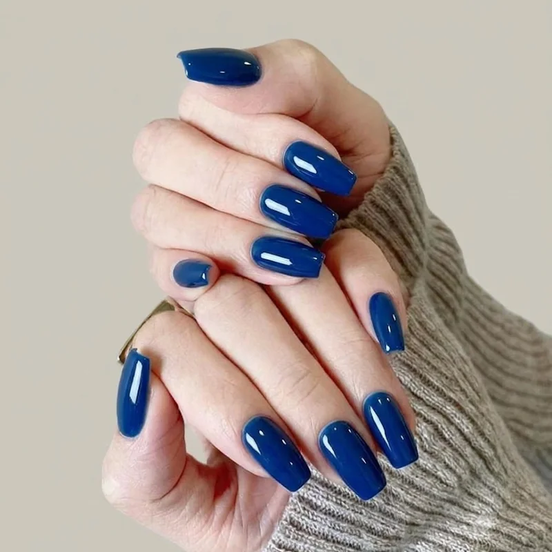 Sapphire blue coffin nails winter manicure with glossy studio-lit finish