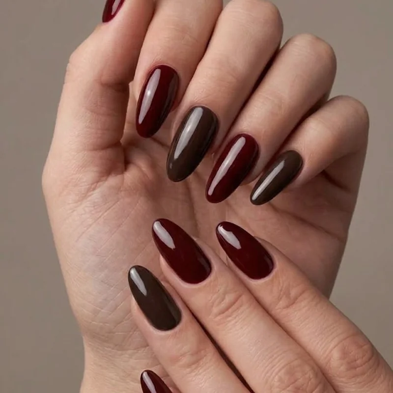 Tortoiseshell pattern nail art in amber and black showing the mottled dark academia technique