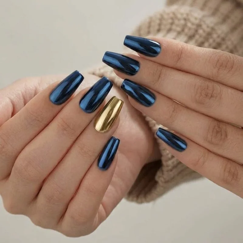 Navy blue nails with gold chrome metallic accent finish for an elevated winter manicure