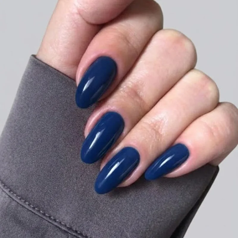 Glossy solid navy blue nail polish manicure with a clean, minimalist quiet-luxury finish